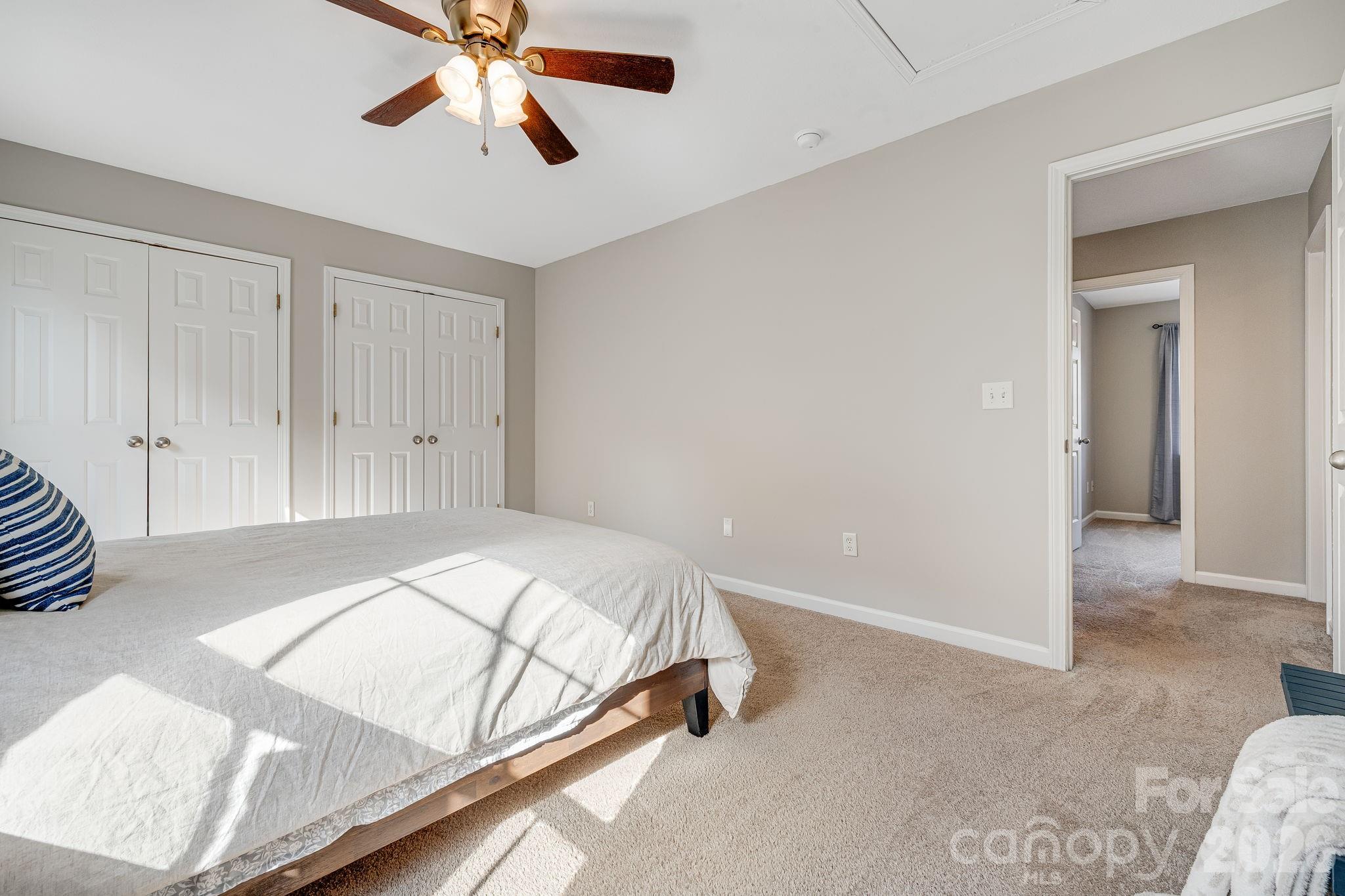 49 Farington Circle Fletcher, NC 28732 - Photo 21 of 32 a bedroom with a bed and a chandelier