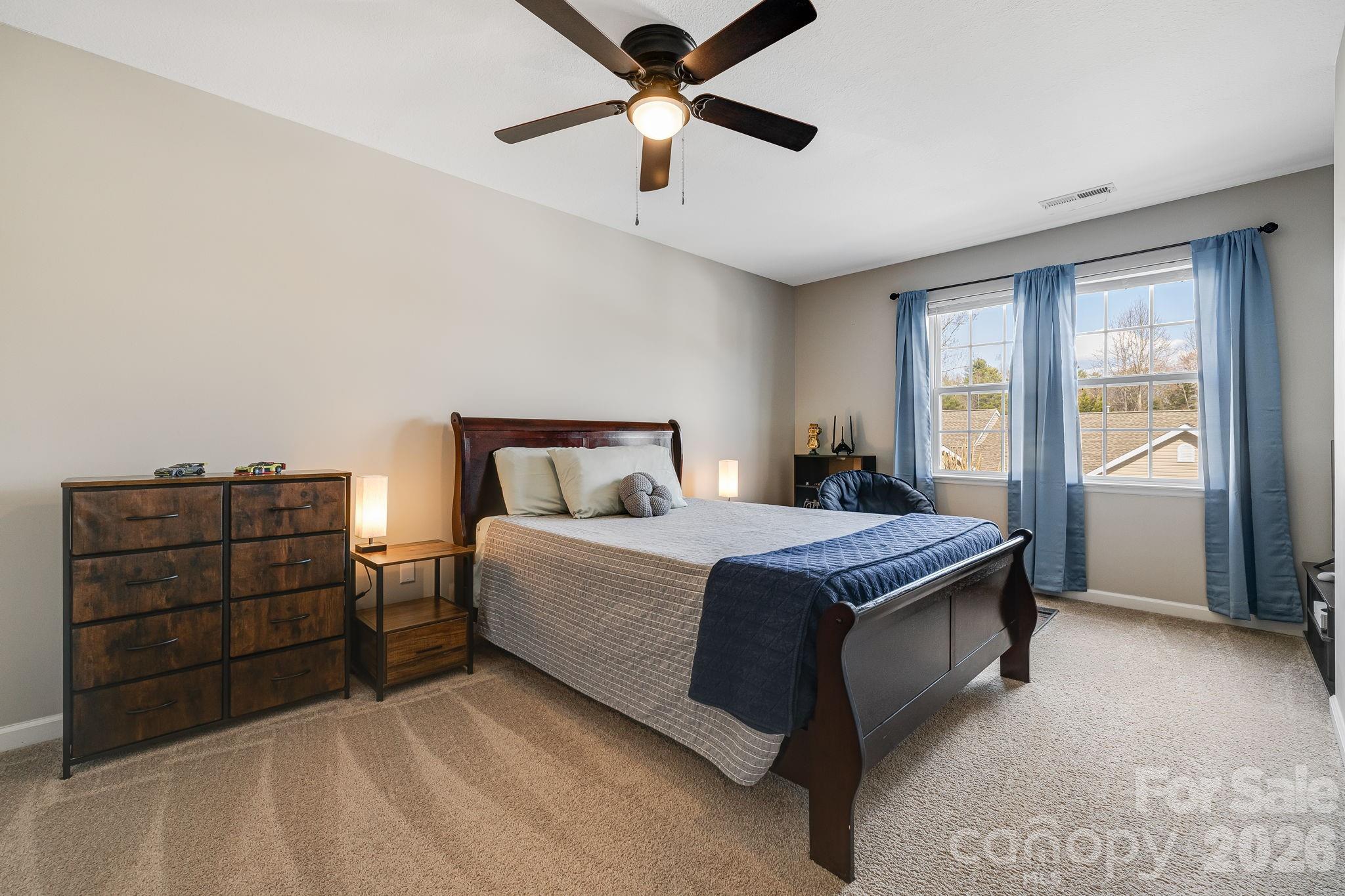 49 Farington Circle Fletcher, NC 28732 - Photo 23 of 32 a bedroom with a bed and a ceiling fan