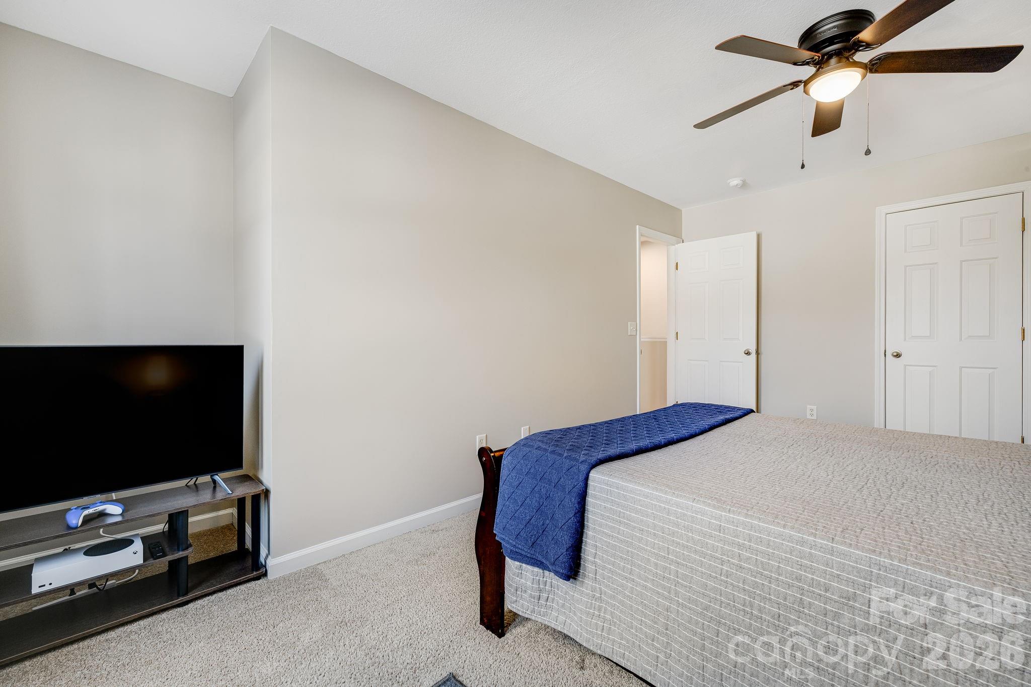 49 Farington Circle Fletcher, NC 28732 - Photo 25 of 32 a bedroom with a bed and a flat screen tv