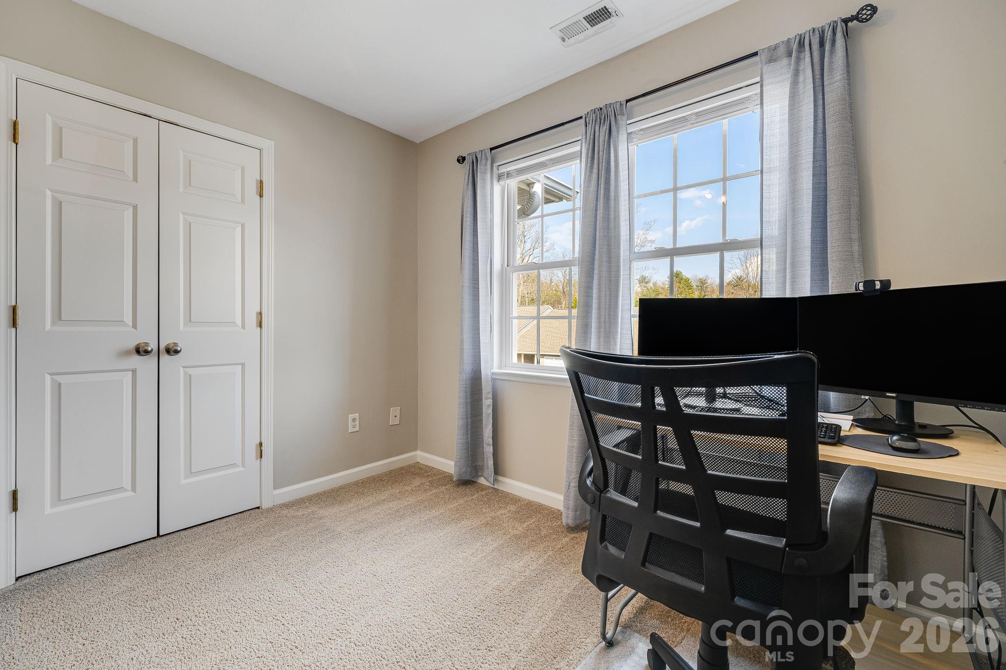 49 Farington Circle Fletcher, NC 28732 - Photo 27 of 32 a living room with a chair and a window