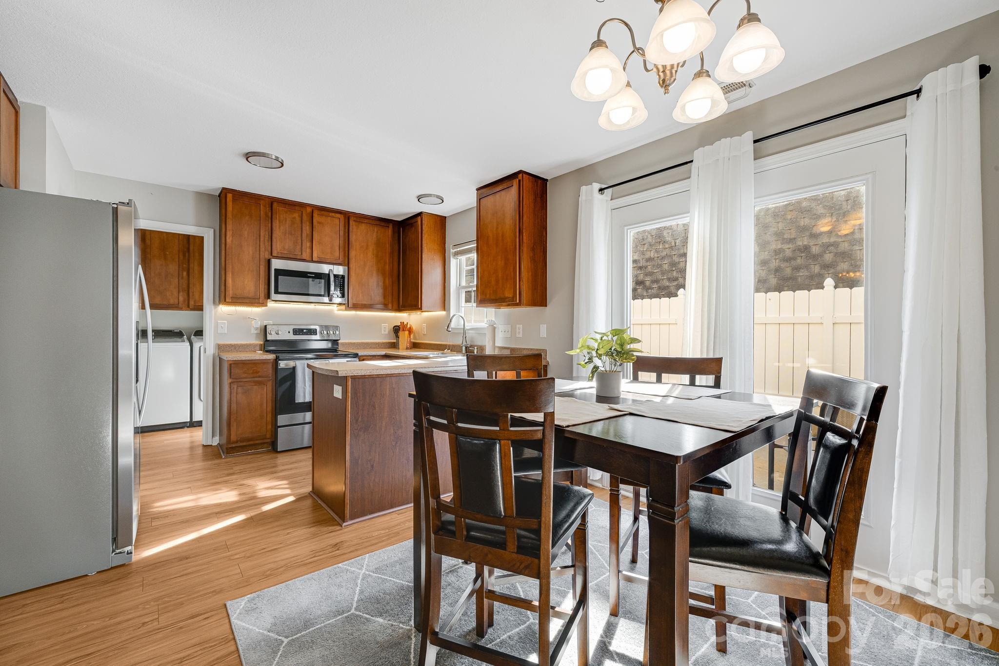 49 Farington Circle Fletcher, NC 28732 - Photo 10 of 32 a view of a dining room with furniture window and wooden floor