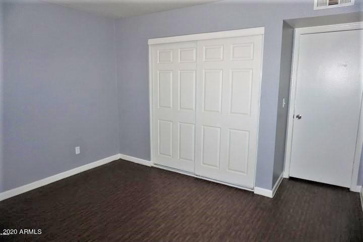18202 North Cave Creek Road, Unit 231 Phoenix, AZ 85032 - Photo 12 of 18 an empty room with wooden floor
