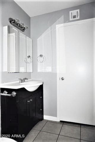 18202 North Cave Creek Road, Unit 231 Phoenix, AZ 85032 - Photo 14 of 18 a bathroom with a sink and a mirror