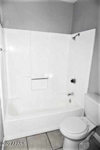 18202 North Cave Creek Road, Unit 231 Phoenix, AZ 85032 - Photo 15 of 18 a bathroom with a toilet and a bath tub