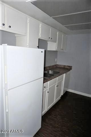 18202 North Cave Creek Road, Unit 231 Phoenix, AZ 85032 - Photo 6 of 18 a white refrigerator freezer sitting in a kitchen