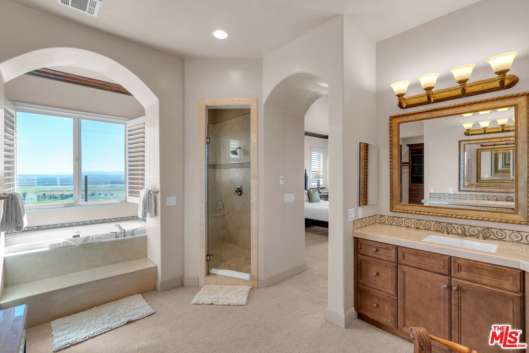 1990 Highway 46 Shandon, CA 93461 - Photo 23 of 57 a spacious bathroom with a shower a sink and a large mirror