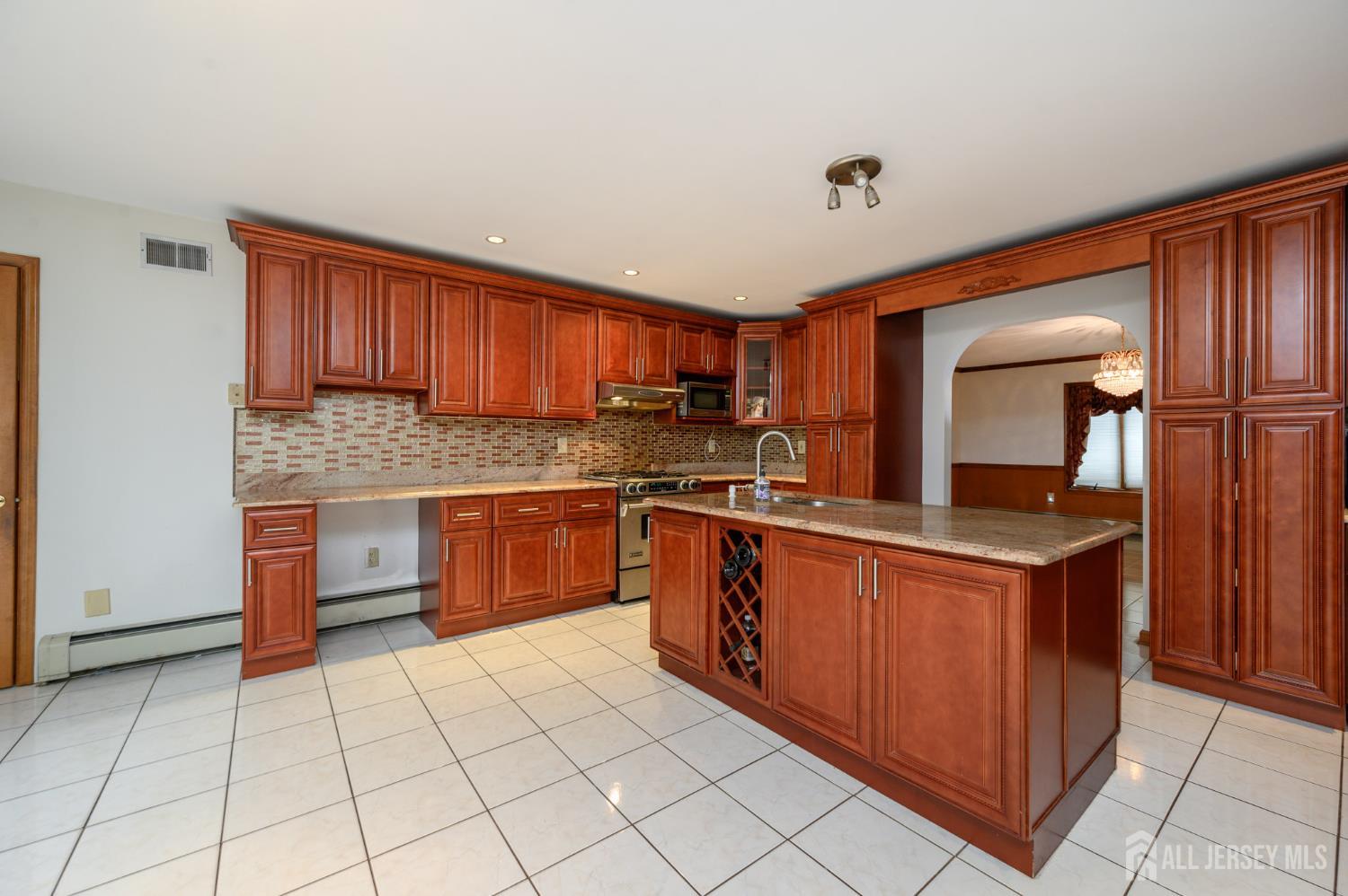 4 Drinking Brook Road Monmouth Junction, NJ 08852 - Photo 8 of 74 a kitchen with stainless steel appliances granite countertop a stove a sink dishwasher and a refrigerator