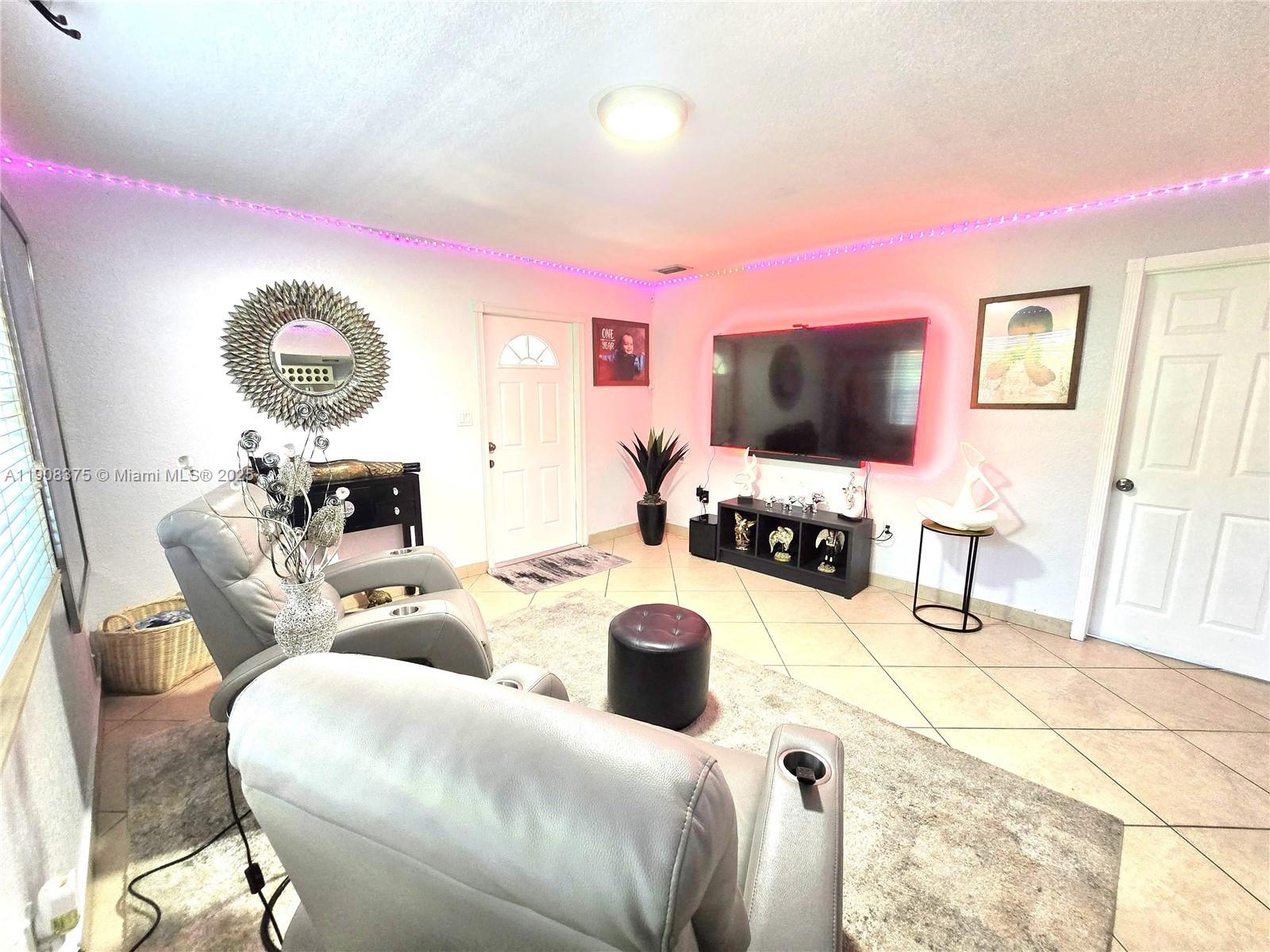 11152 Southwest 7th Street Sweetwater, FL 33174 - Photo 17 of 52 a living room with furniture and a flat screen tv