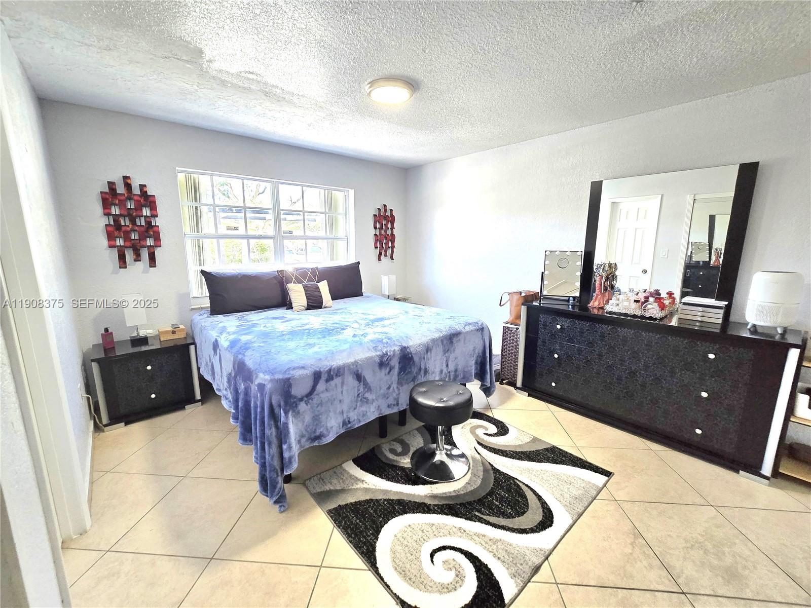 11152 Southwest 7th Street Sweetwater, FL 33174 - Photo 20 of 53 a bed room with a bed and a window