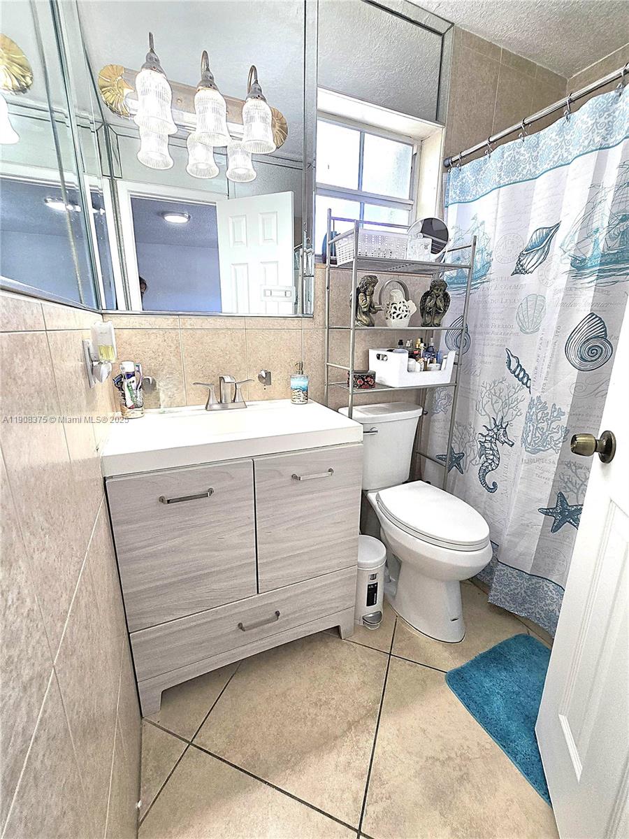 11152 Southwest 7th Street Sweetwater, FL 33174 - Photo 22 of 52 a bathroom with a sink a toilet and shower