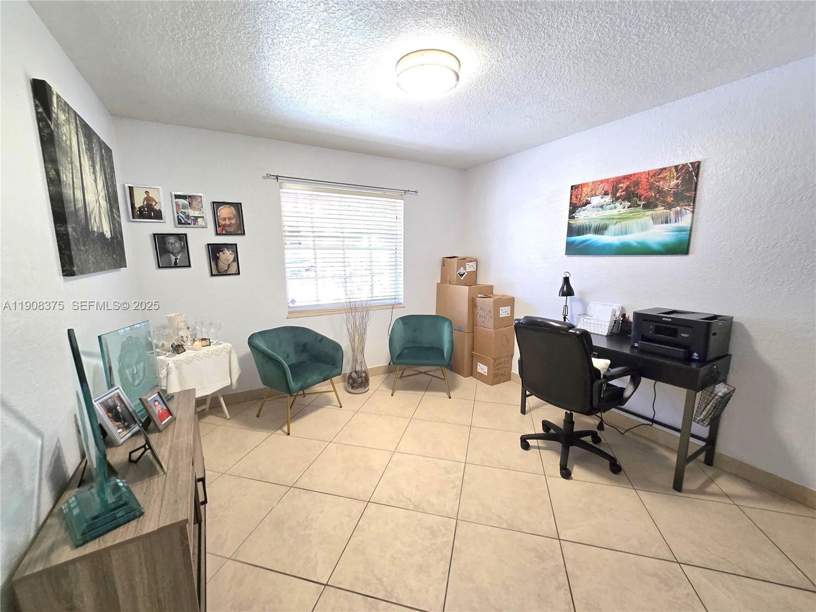 11152 Southwest 7th Street Sweetwater, FL 33174 - Photo 24 of 53 a view of a workspace with furniture and a large window