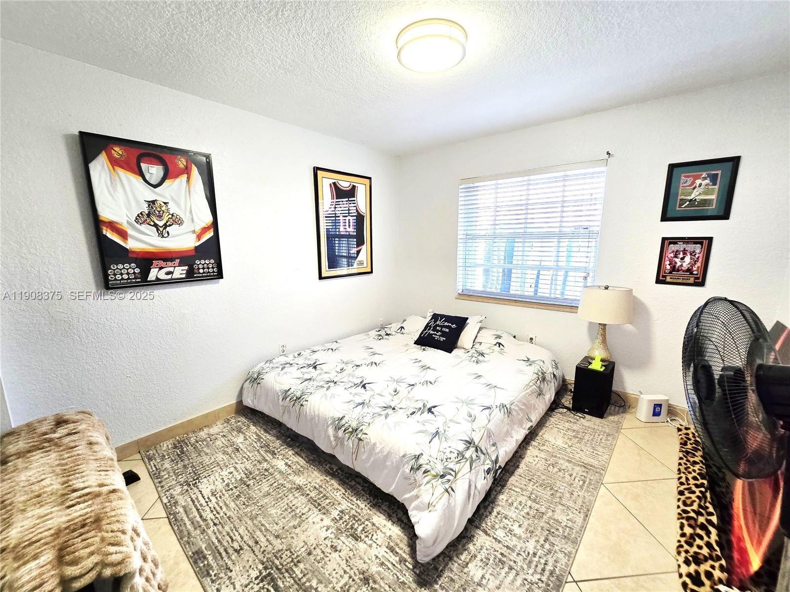 11152 Southwest 7th Street Sweetwater, FL 33174 - Photo 26 of 53 a bedroom with a bed and a large window