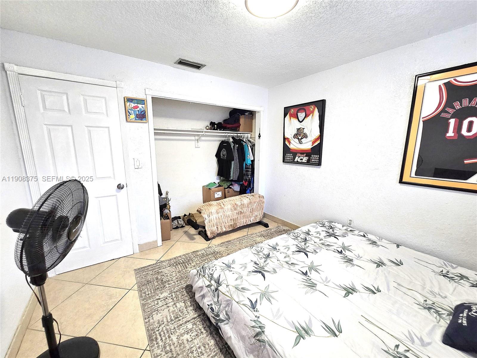 11152 Southwest 7th Street Sweetwater, FL 33174 - Photo 27 of 53 a bedroom with a bed and a painting on the wall