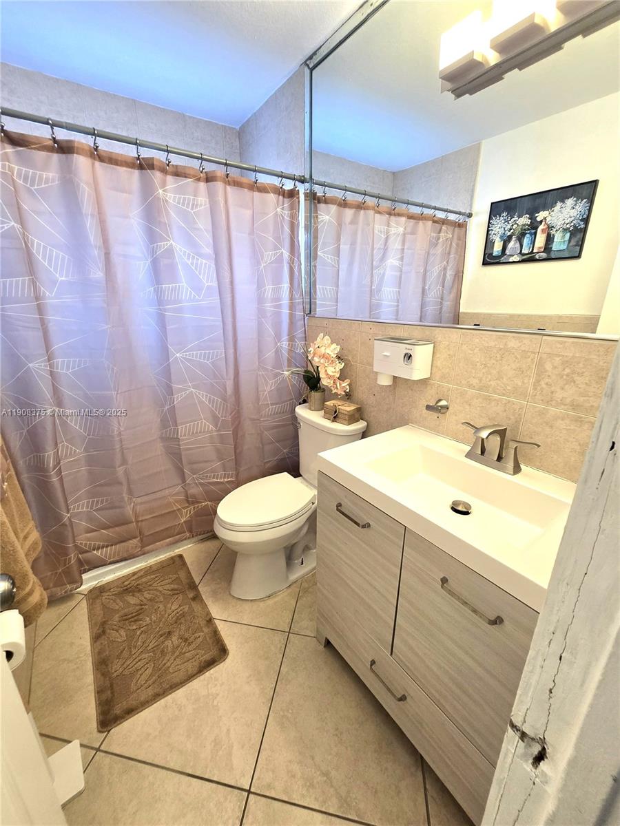 11152 Southwest 7th Street Sweetwater, FL 33174 - Photo 29 of 52 a bathroom with a sink a toilet and shower