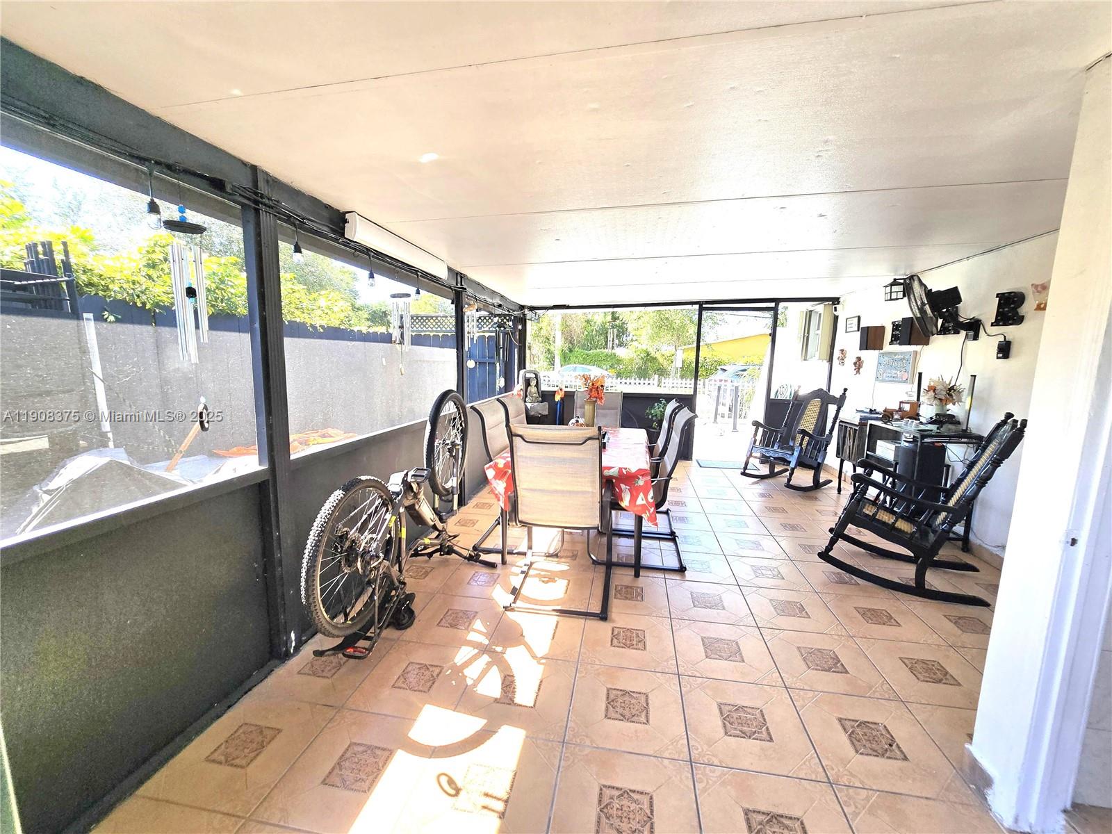 11152 Southwest 7th Street Sweetwater, FL 33174 - Photo 30 of 52 a view of a dining room with furniture and floor to ceiling windows