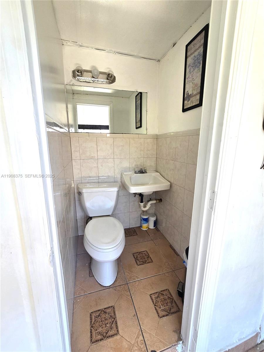 11152 Southwest 7th Street Sweetwater, FL 33174 - Photo 34 of 53 a bathroom with a toilet and a sink