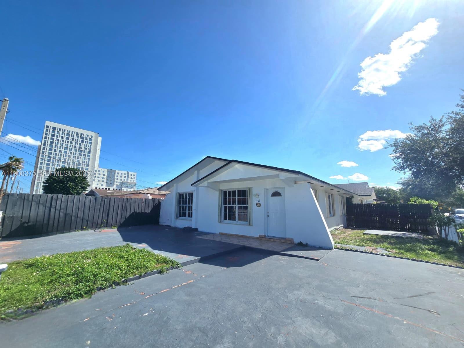 11152 Southwest 7th Street Sweetwater, FL 33174 - Photo 39 of 53 a front view of a house with garden