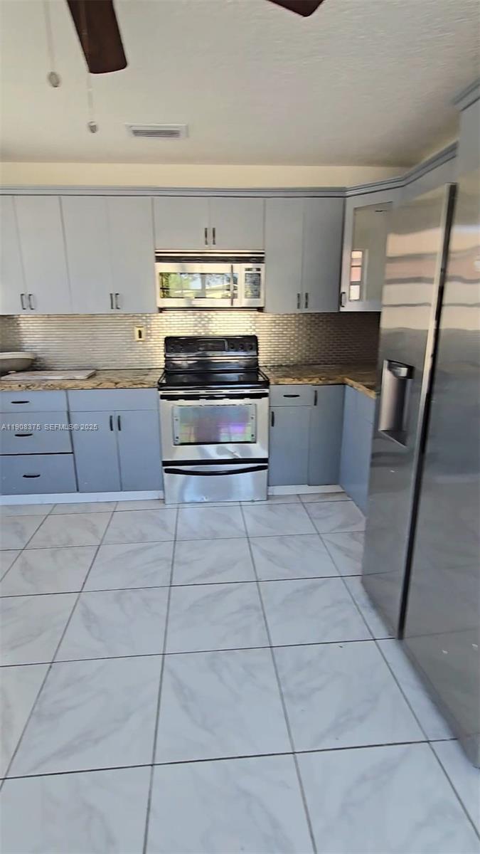 11152 Southwest 7th Street Sweetwater, FL 33174 - Photo 45 of 53 a kitchen with stainless steel appliances and cabinets