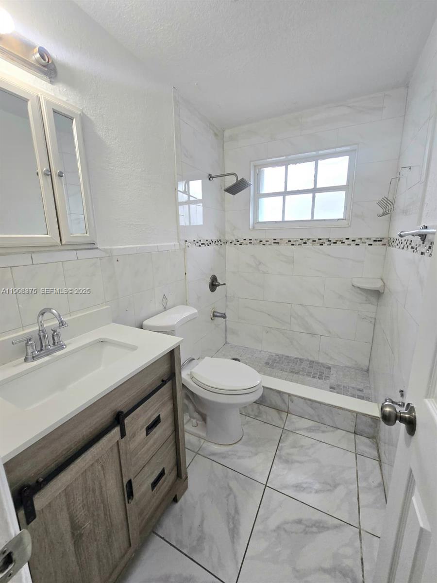 11152 Southwest 7th Street Sweetwater, FL 33174 - Photo 49 of 53 a bathroom with a sink a toilet and mirror
