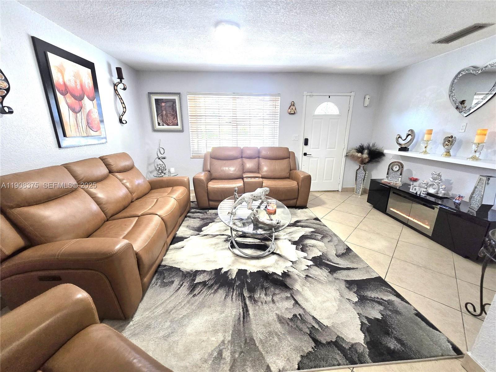 11152 Southwest 7th Street Sweetwater, FL 33174 - Photo 10 of 53 a living room with furniture and painting on the wall