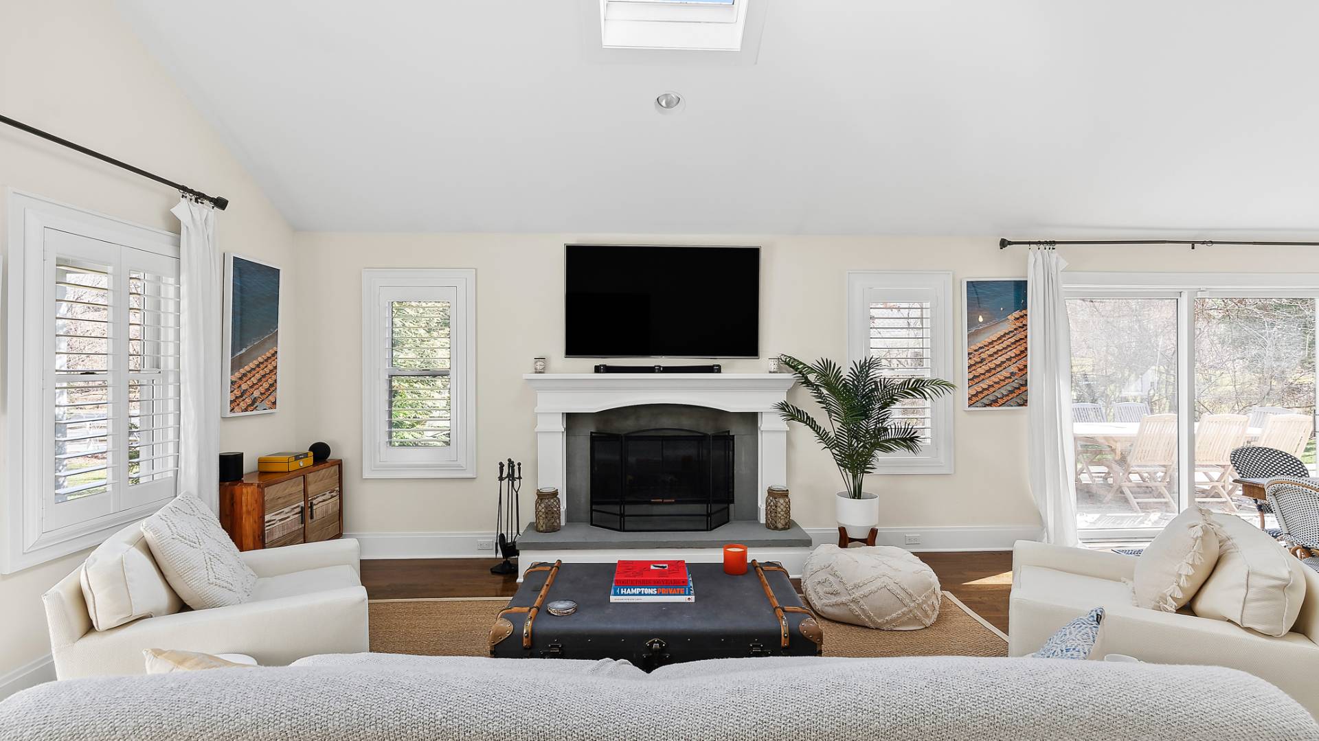 4 Arthur Avenue Bridgehampton, NY 11932 - Photo 3 of 13 a living room with furniture a flat screen tv and a fireplace