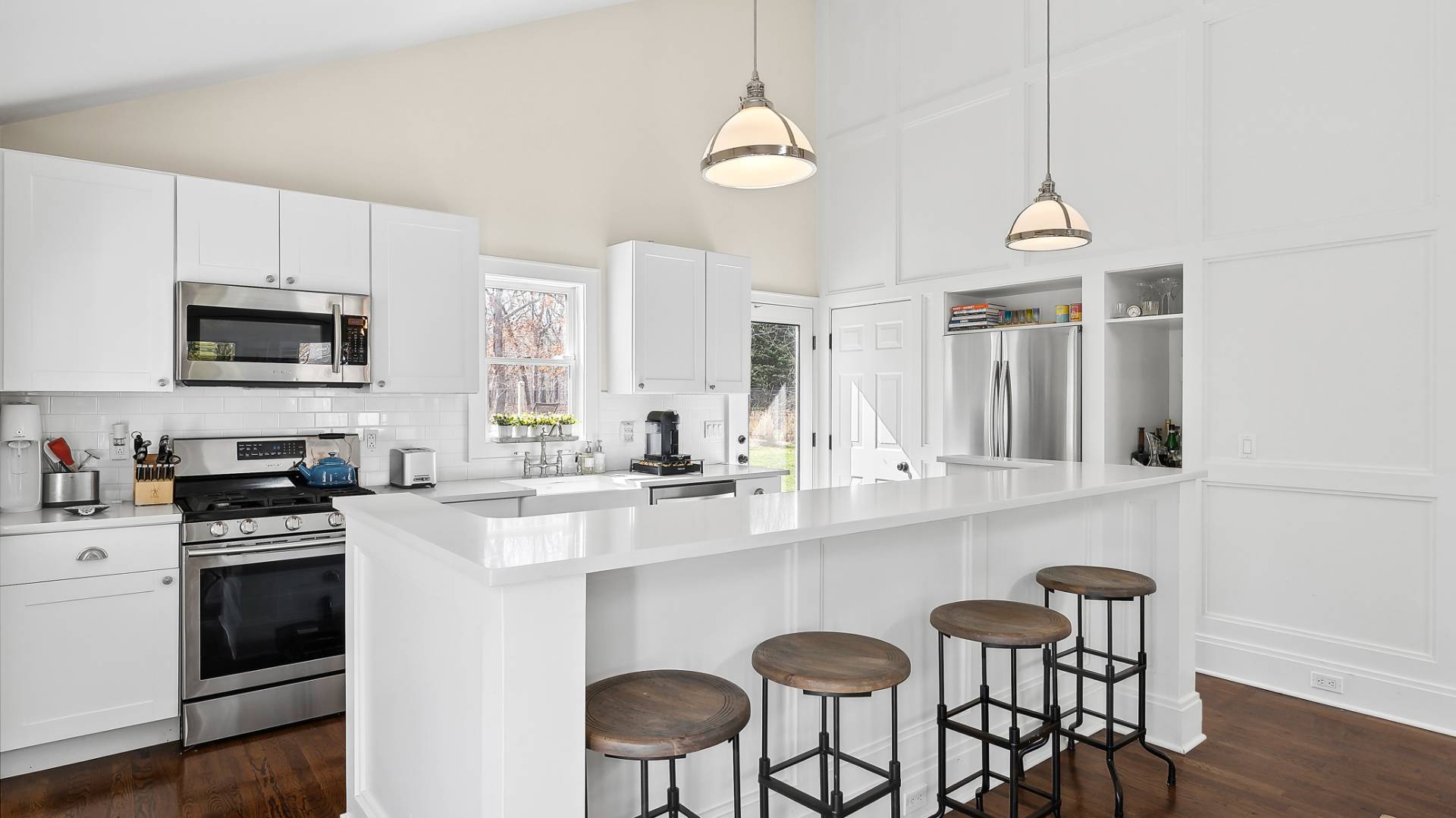 4 Arthur Avenue Bridgehampton, NY 11932 - Photo 5 of 13 a kitchen with stainless steel appliances a sink a stove a microwave a refrigerator and cabinets