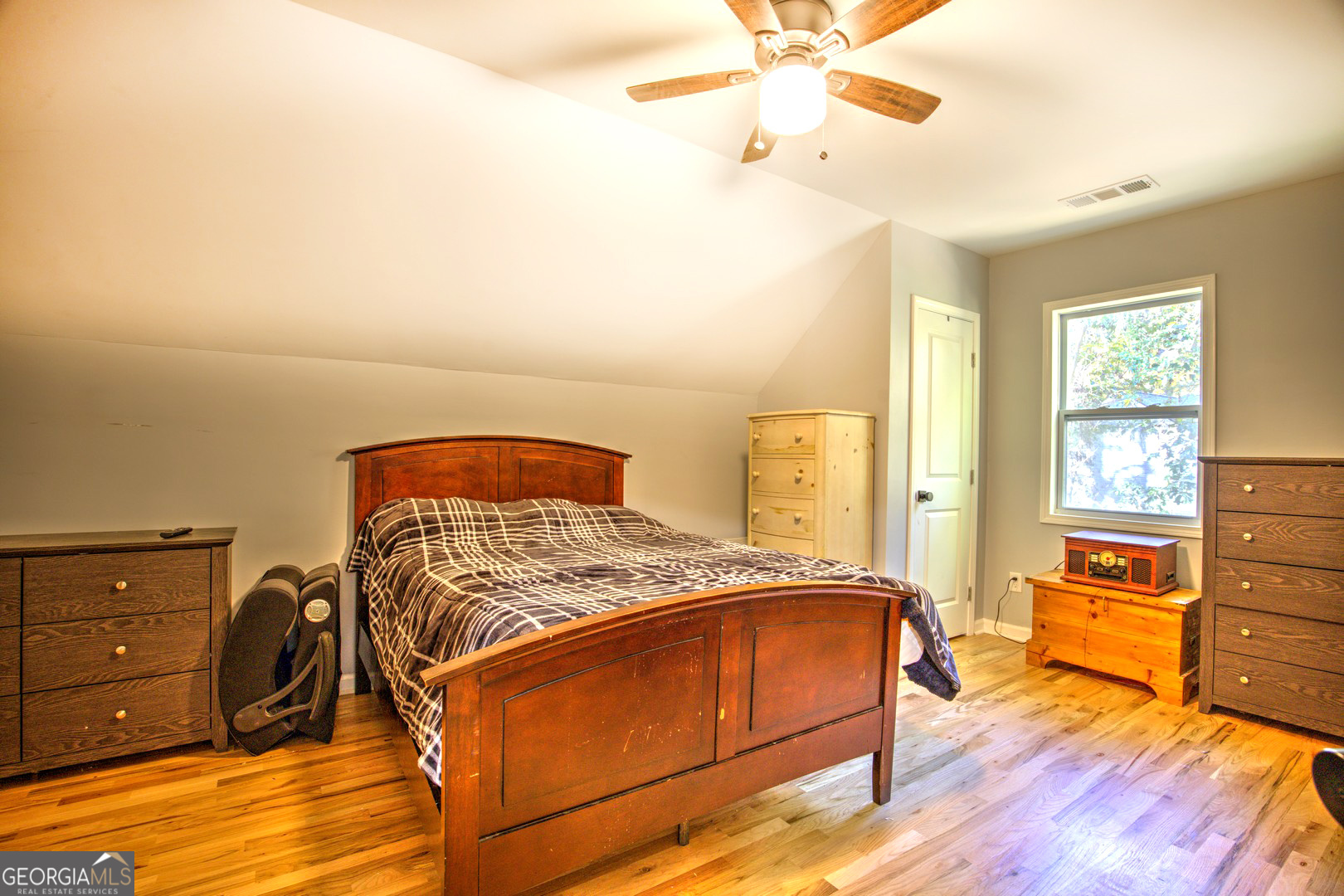 13 Goldfinch Circle Monticello, GA 31064 - Photo 43 of 44 a bedroom with a bed and wooden floor