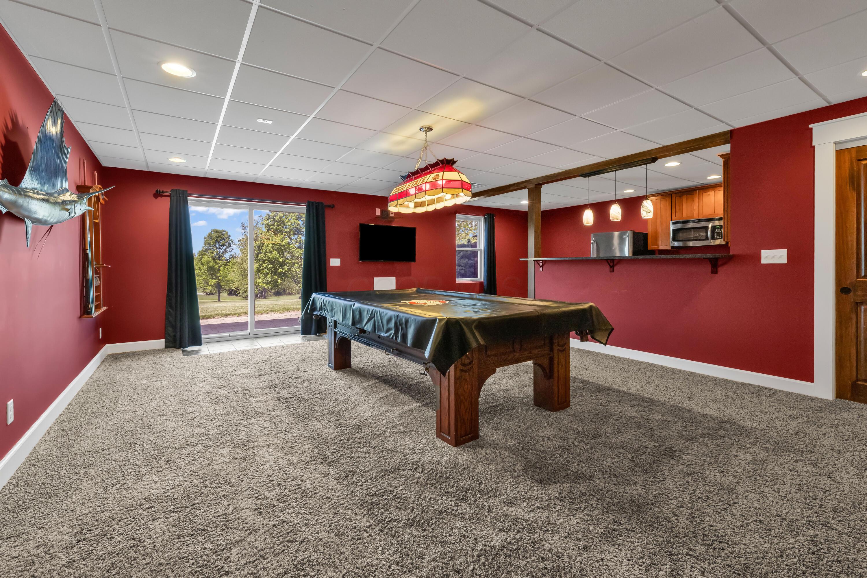 16689 Bailor Road Laurelville, OH 43135 - Photo 47 of 73 • Light sand carpet
• Burgundy painted walls
• Pool table & light remains
• Double sliding doors to
paver patio
• Closet with double sliding doors