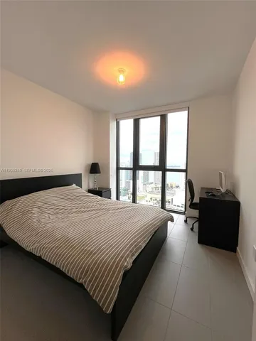 a bathroom with a double vanity sink a toilet a mirror and shower