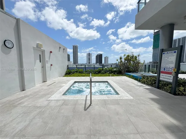 a view of swimming pool in front of residential houses with outdoor seating
