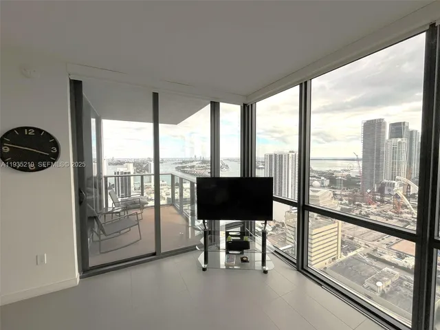 a living room with furniture and large windows