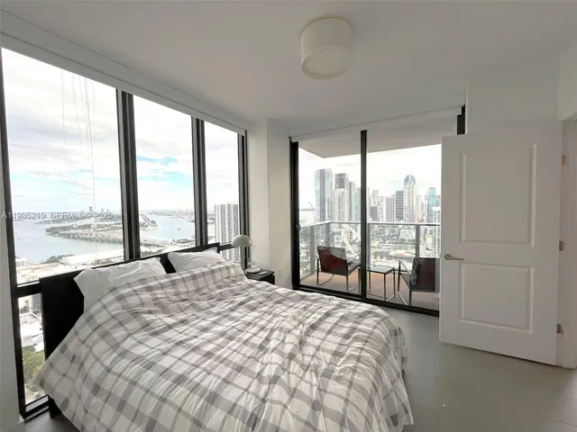 a bathroom with a sink a toilet a mirror and bathtub