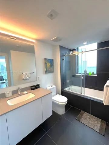 a kitchen with stainless steel appliances a refrigerator and a stove top oven