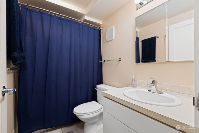 a bedroom with a bed and a mirror