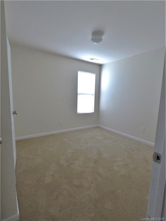 1020 Rook Road Charlotte, NC 28216 - Photo 14 of 21 an empty room with a window and a mirror