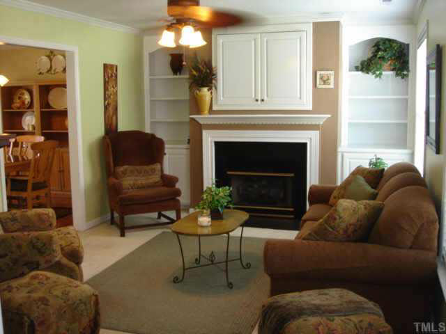 2140 Haig Point Way Raleigh, NC 27604 - Photo 3 of 10 The gas logs and built in bookshelves add character and a nice finishing touch to this family room.