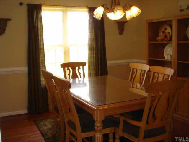 2140 Haig Point Way Raleigh, NC 27604 - Photo 4 of 10 This picture doesn't do the dining room justice. Hardwood floors and the view out to the golf course give this room the setting that will draw you to eat every meal sitting at the dining room table.