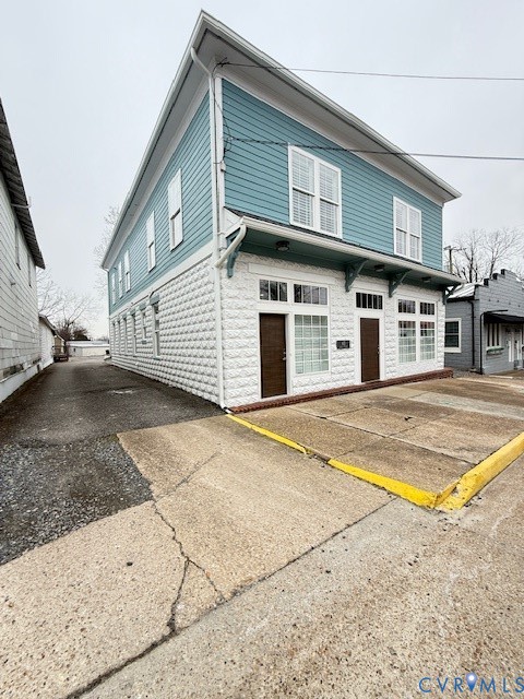 45 Cross Street, Unit B Urbanna, VA 23175 - Photo 1 of 25 a view of a white building with a outdoor space