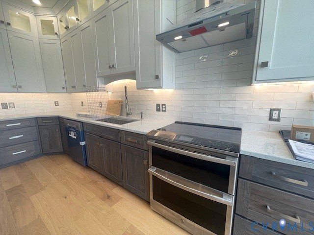 45 Cross Street, Unit B Urbanna, VA 23175 - Photo 11 of 25 a kitchen with a stove a sink and a refrigerator