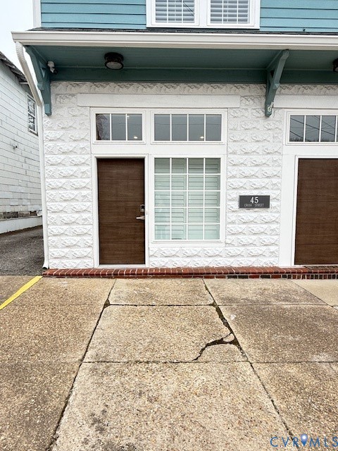 45 Cross Street, Unit B Urbanna, VA 23175 - Photo 2 of 25 a front view of a house with a yard