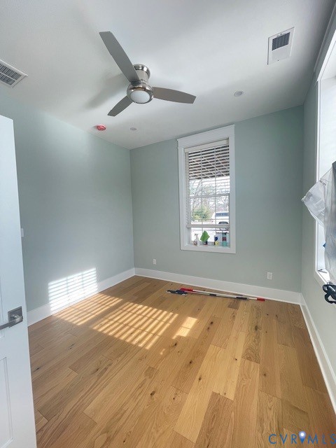 45 Cross Street, Unit B Urbanna, VA 23175 - Photo 21 of 25 an empty room with wooden floor fan and windows