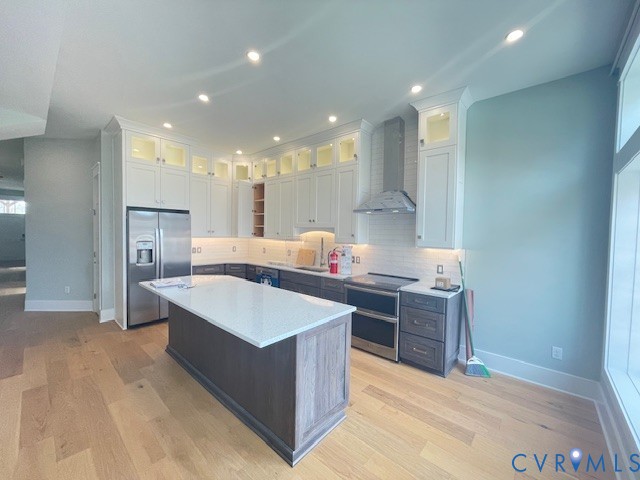 45 Cross Street, Unit B Urbanna, VA 23175 - Photo 10 of 25 a large kitchen with kitchen island a sink stainless steel appliances and cabinets