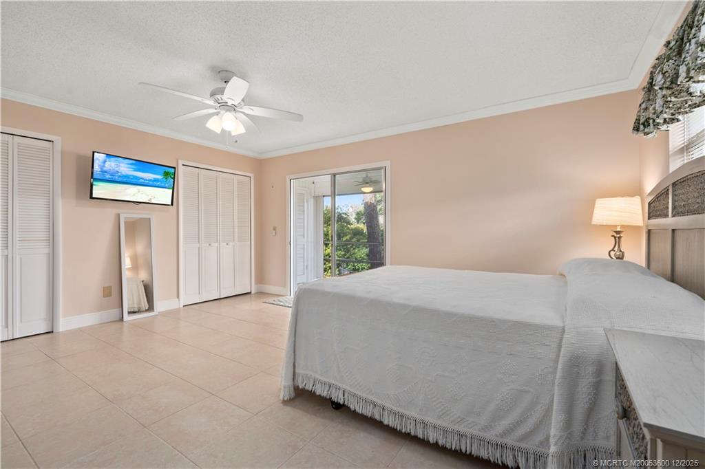 2600 Southeast Ocean Boulevard, Unit EE12 Stuart, FL 34996 - Photo 15 of 43 a bedroom with a bed and a chandelier