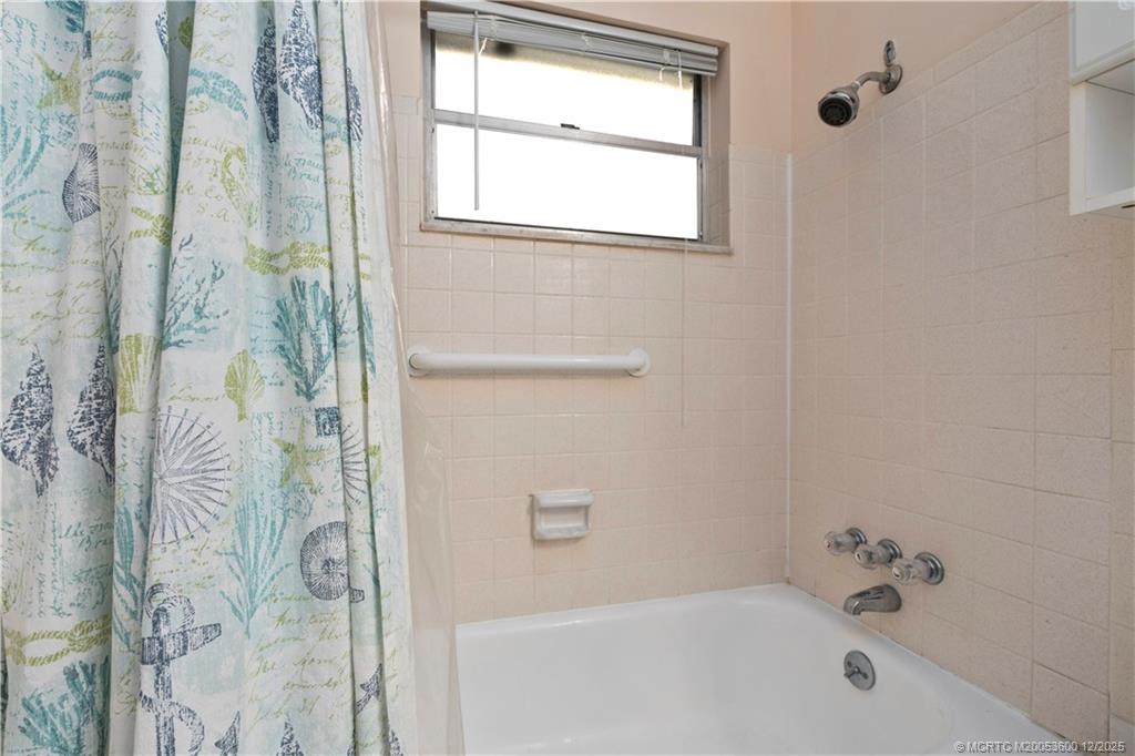 2600 Southeast Ocean Boulevard, Unit EE12 Stuart, FL 34996 - Photo 17 of 43 a bathroom with a bathtub and shower