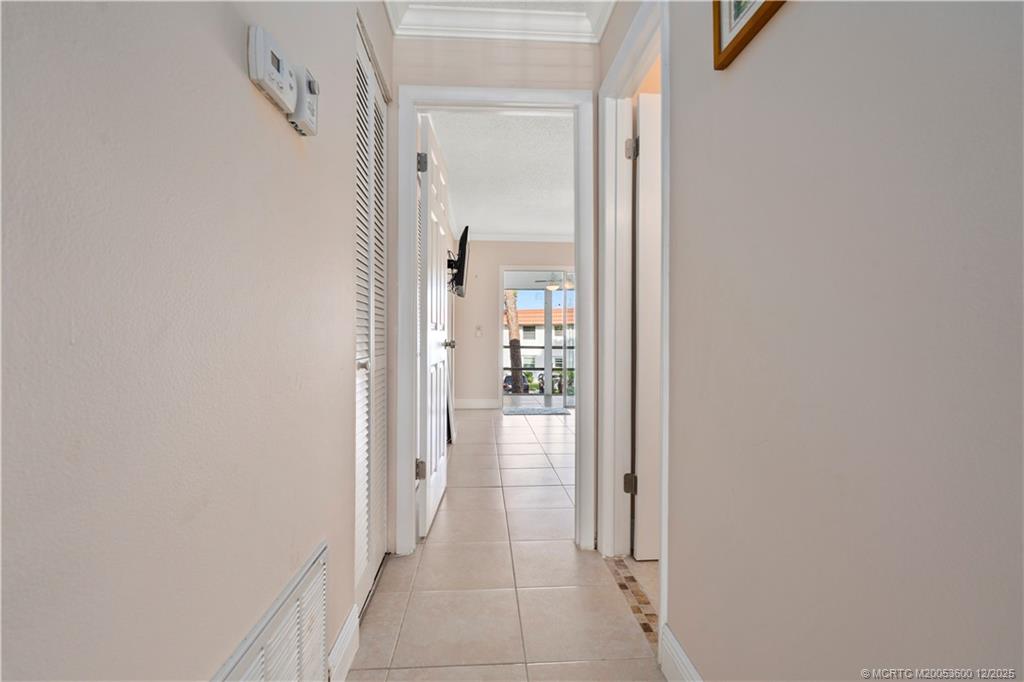 2600 Southeast Ocean Boulevard, Unit EE12 Stuart, FL 34996 - Photo 18 of 43 a view of a hallway with wooden floor and a bathroom