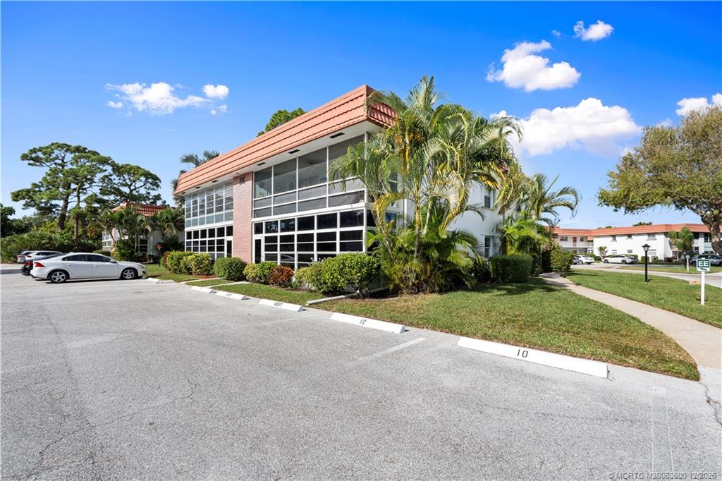 2600 Southeast Ocean Boulevard, Unit EE12 Stuart, FL 34996 - Photo 25 of 43 a view of a house with a yard and potted plants