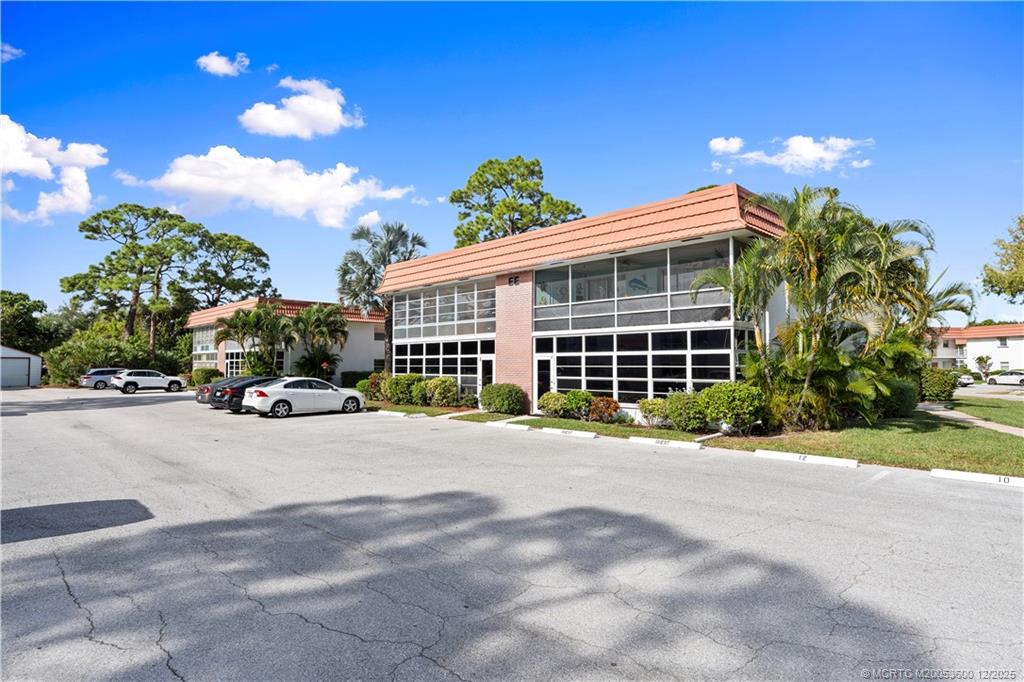 2600 Southeast Ocean Boulevard, Unit EE12 Stuart, FL 34996 - Photo 26 of 43 a view of a house with a yard and a garage
