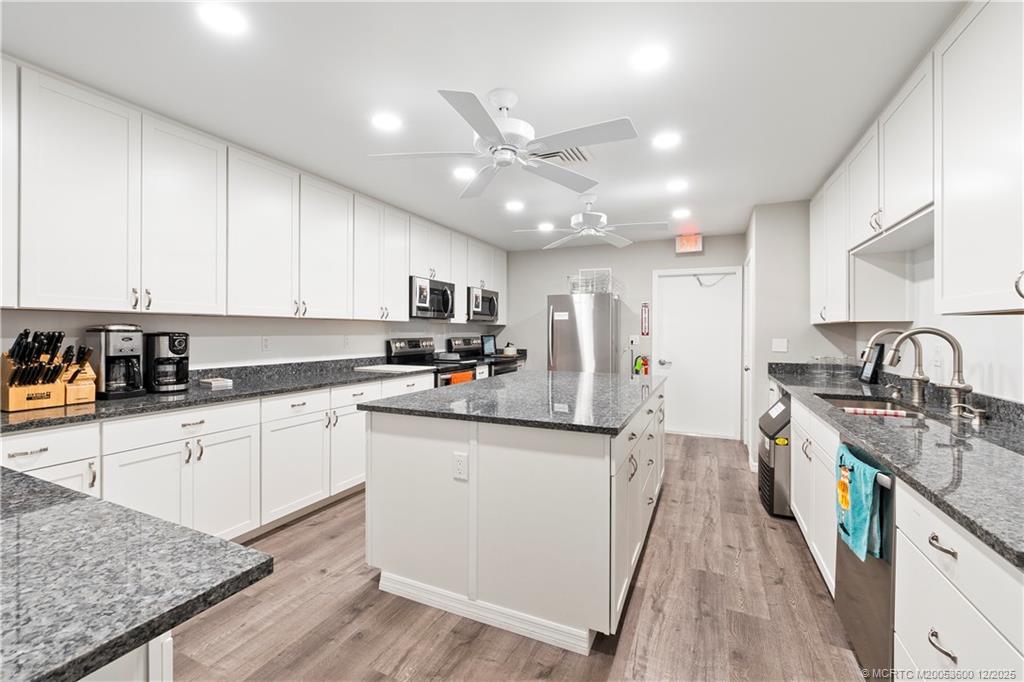2600 Southeast Ocean Boulevard, Unit EE12 Stuart, FL 34996 - Photo 37 of 43 a kitchen with stainless steel appliances granite countertop a sink stove and refrigerator