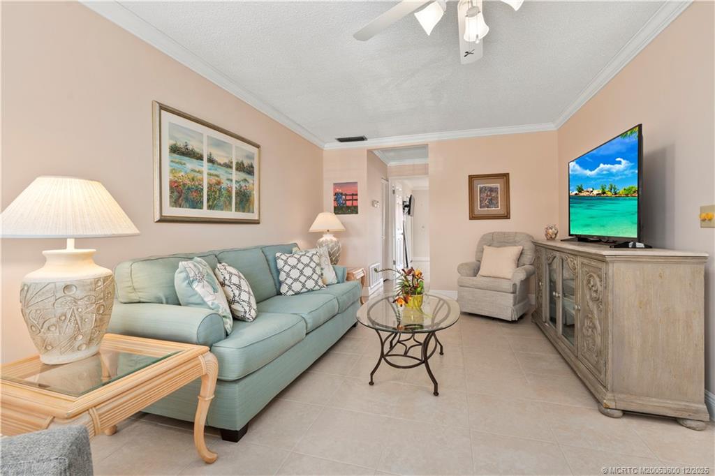 2600 Southeast Ocean Boulevard, Unit EE12 Stuart, FL 34996 - Photo 5 of 43 a living room with furniture and a flat screen tv