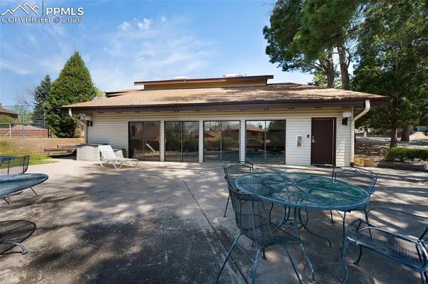 a view of a house with backyard and sitting area